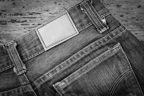 Leather jeans label sewed on blue jeans. — Stock Photo, Image