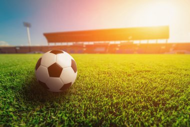 Soccer ball on grass in soccer stadium. clipart