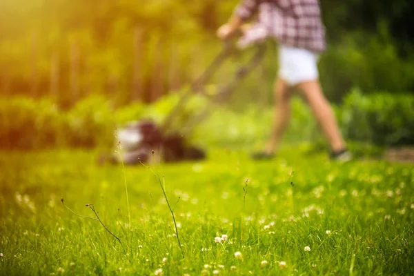 Young man mowing lawn — Stock Photo, Image