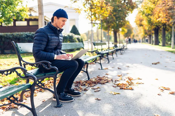 Young man in a cap on a bench Royalty Free Stock Photos