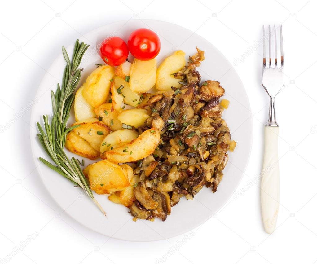 Dish with fried potatoes and cepes isolated on a white backgroun