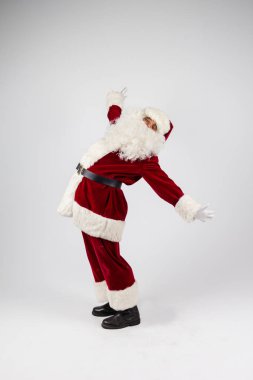 Noel Baba gözlük ve beyaz arka plan üzerinde eller yukarı atma ve kameraya bakarak kırmızı kostüm. 