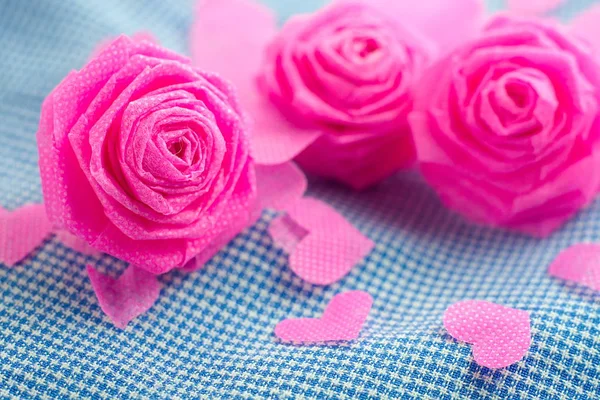 Pink rose and small hart on blue cloth background for Valentine — Stock Photo, Image