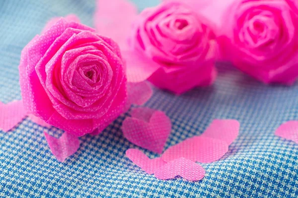 Pink rose and small hart on blue cloth background for Valentine — Stock Photo, Image