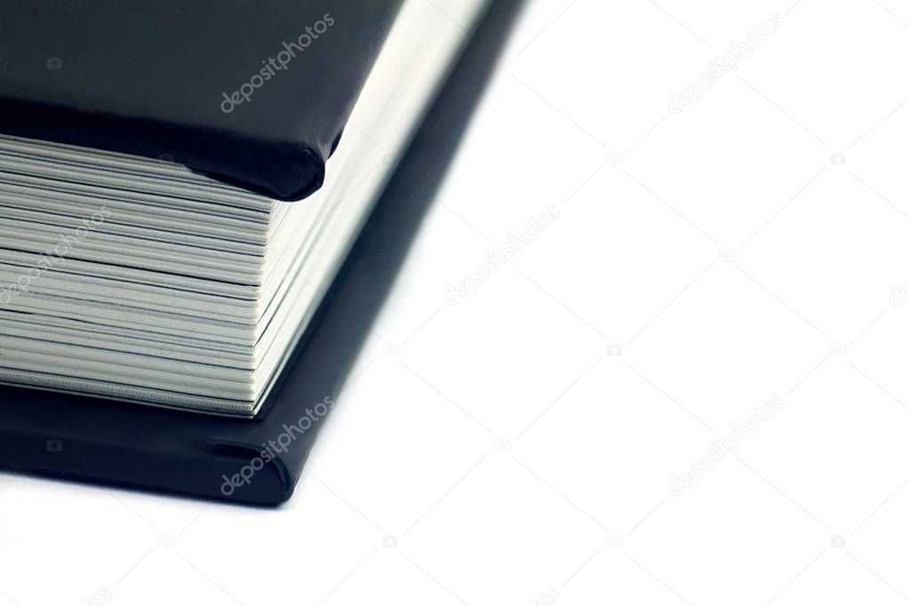 Close up black book spine on white background. For education concept