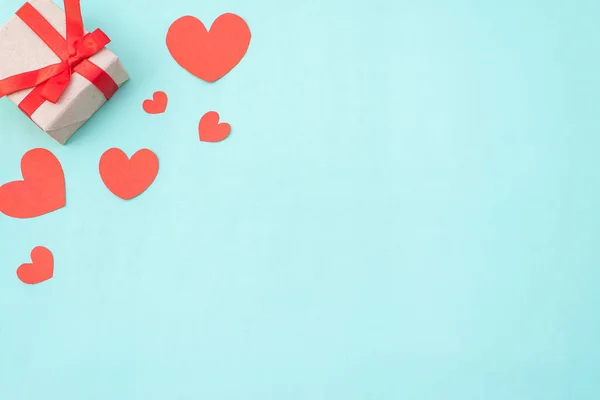 Gift box, red and white hearts on blue pastel background. Valentine's day or wedding ceremony concept and design