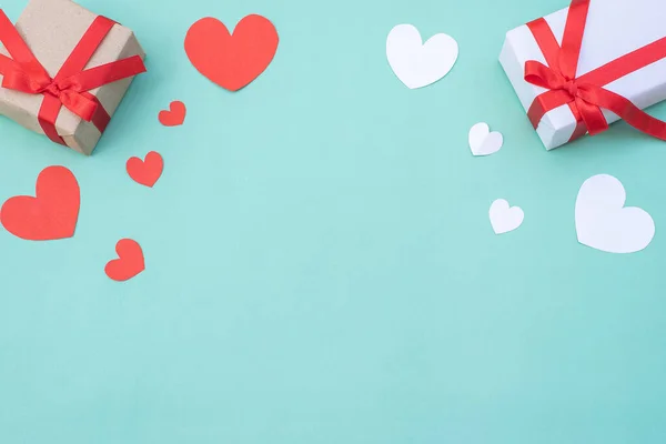 Gift box, red and white hearts on blue pastel background. Valentine's day or wedding ceremony concept and design