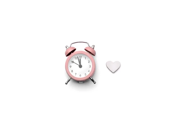 Pink alarm clock and wooden heart isolated on white background — Stock Photo, Image