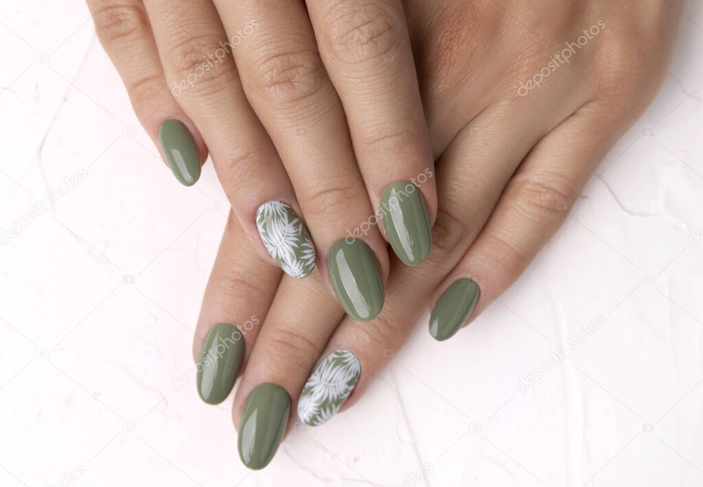 Beautiful womans hands with spring summer floral nail design