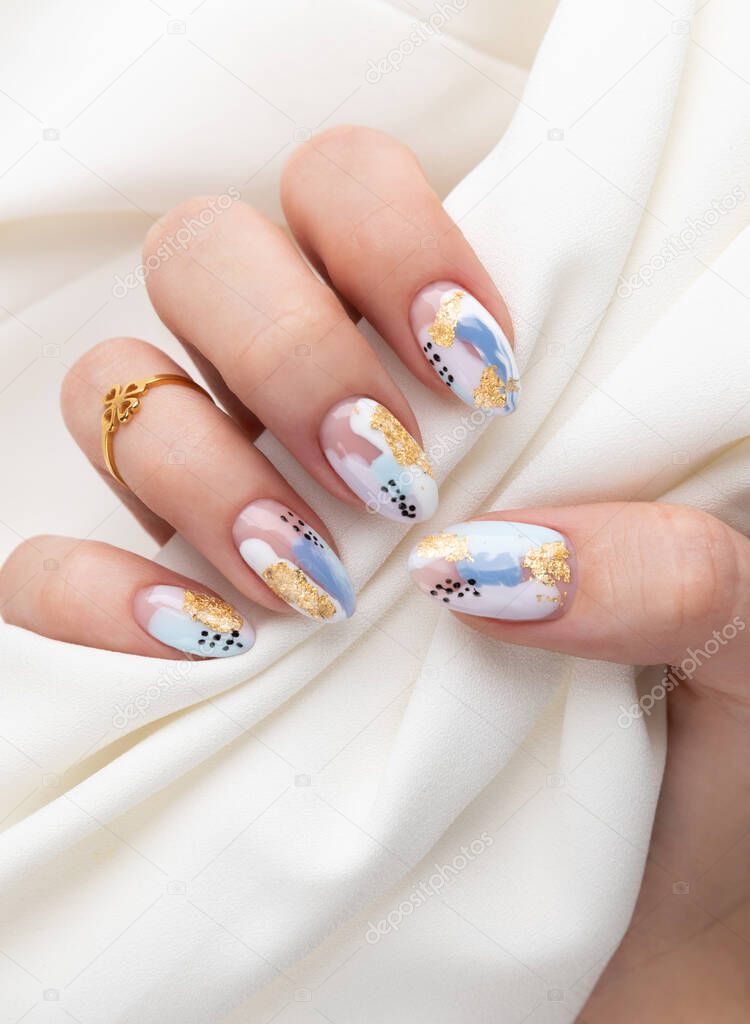 Woman's hand with fashionable nails holding fabric. Spring summer nail design. Manicure, pedicure beauty salon concept.