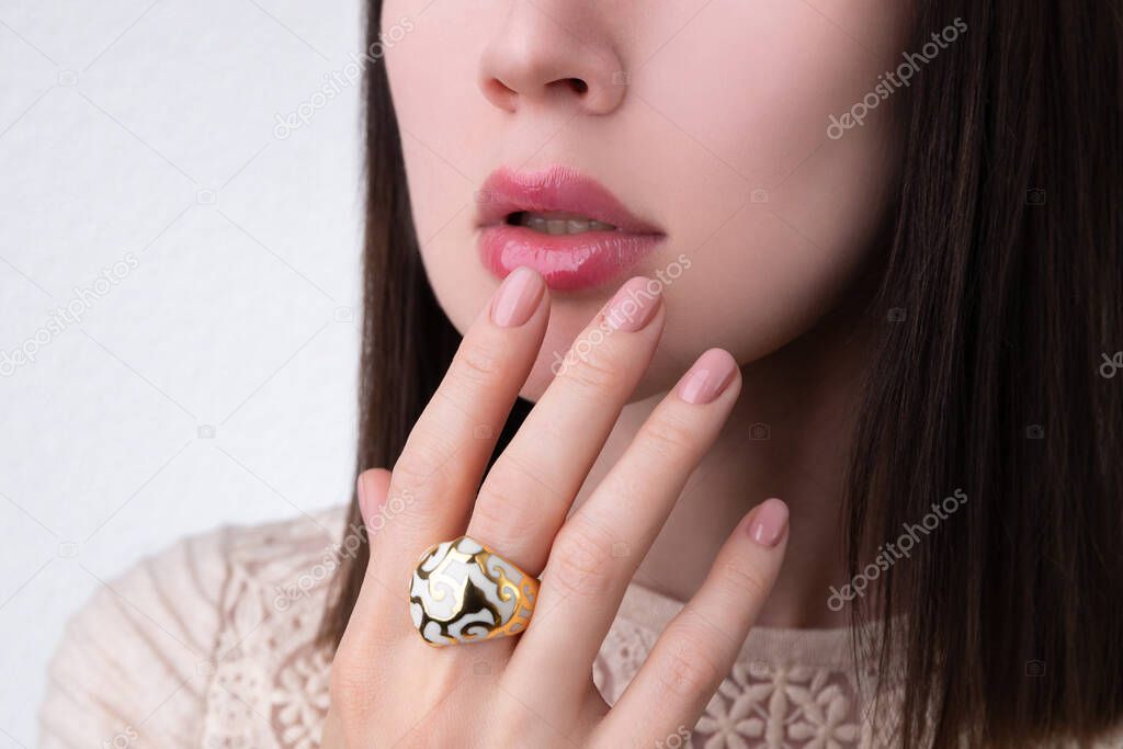 Woman with groomed hands with nude beige pink nail design in dress. Manicure, fashion and beauty salon concept
