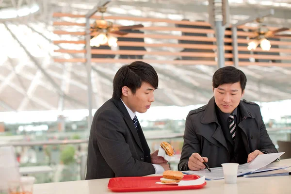 two businessmen discussing a meeting at the restaurant