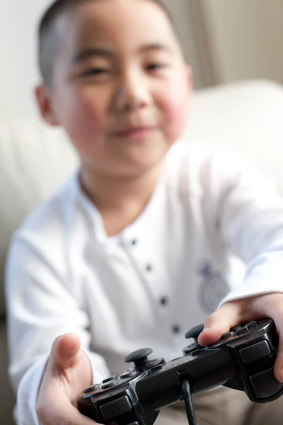 boy playing video game console