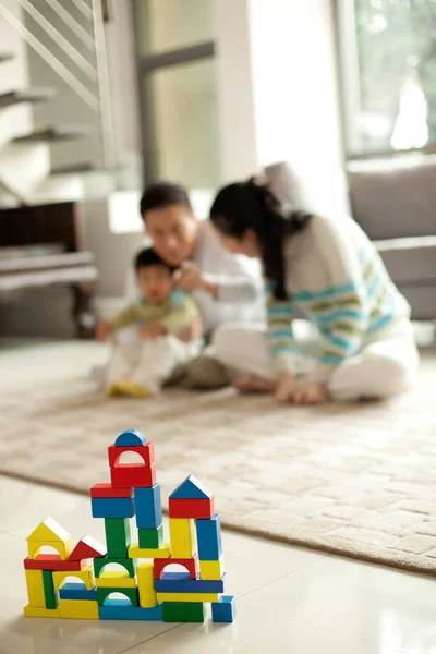 young woman playing with toy blocks at home