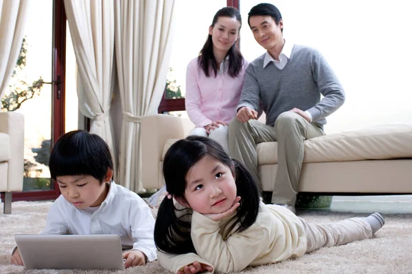 happy family using laptop at home