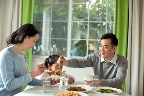 asian family having dinner together at home