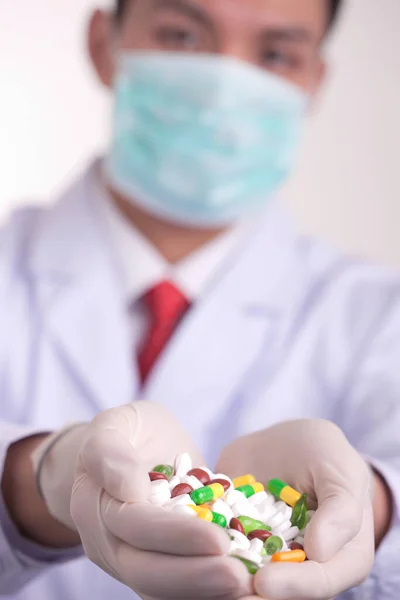 doctor with pills and pill in hands