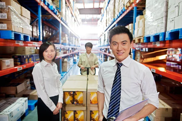 young asian business people working in the warehouse