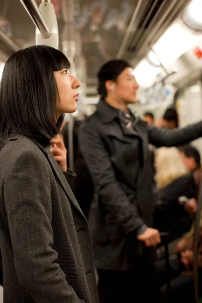 young woman in a suit with a backpack in the subway