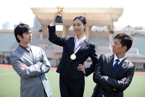 portrait of a young business woman with a trophy