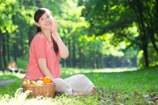 young woman with apple and apples in the park