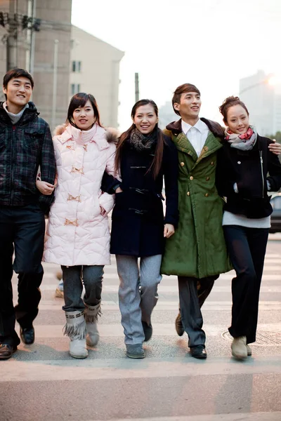 group of young people walking in the city