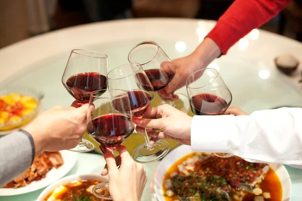 people, eating, food and drink concept-close up of friends clinking glasses with wine and glass of