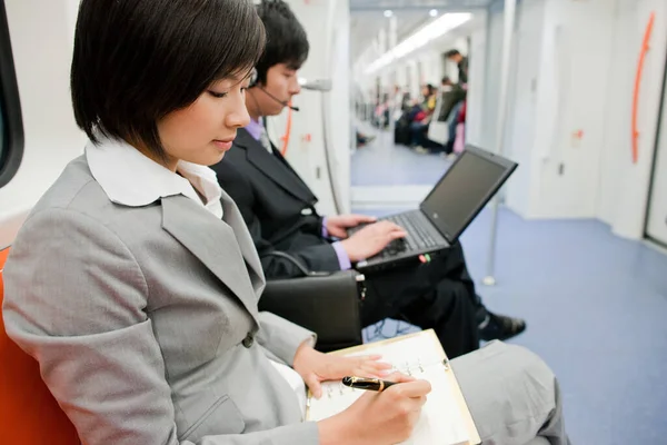 young woman with laptop and mobile phone