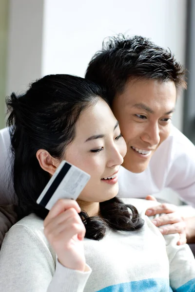 couple with credit card and tablet computer