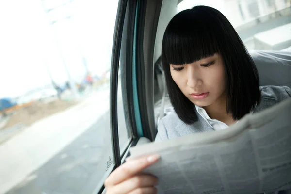 woman reading a book in the car