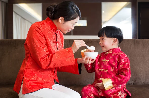 chinese new year. family with a cup of tea and a child