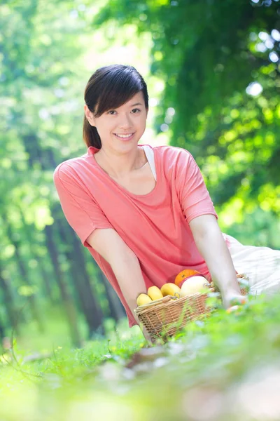asian woman with basket of fruits