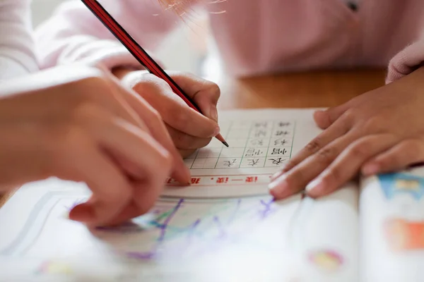 girl draws a pencil on the table