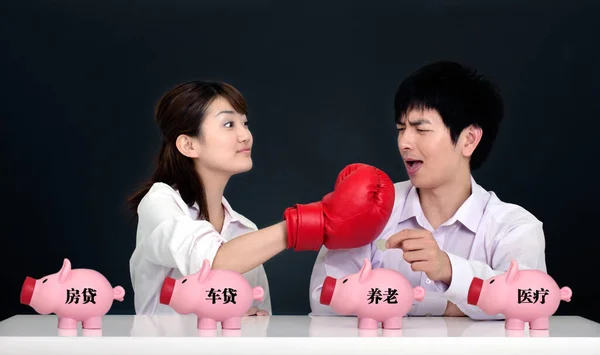 couple with piggy bank and a red heart on a black background