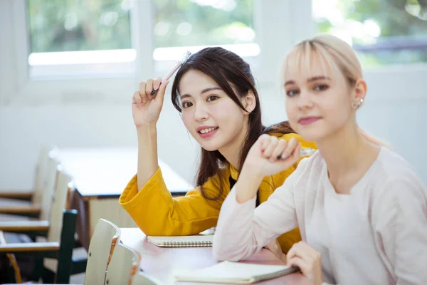 group of young students studying in the cafe