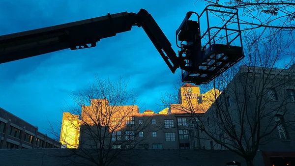 the excavator is a heavy crane on the background of the blue sky.