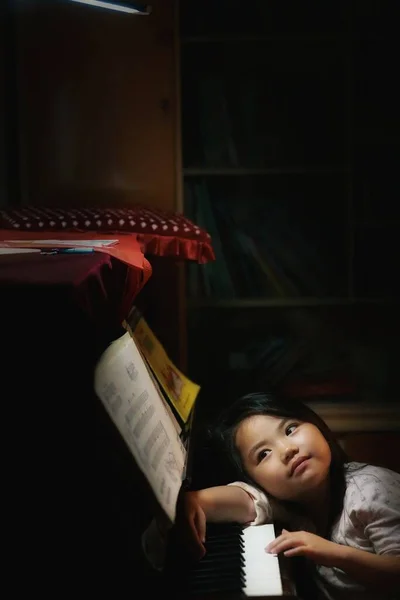 portrait of a girl reading a book in the room