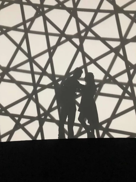 silhouette of a man and woman in a black suit