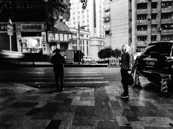 black and white photo of a street in the city