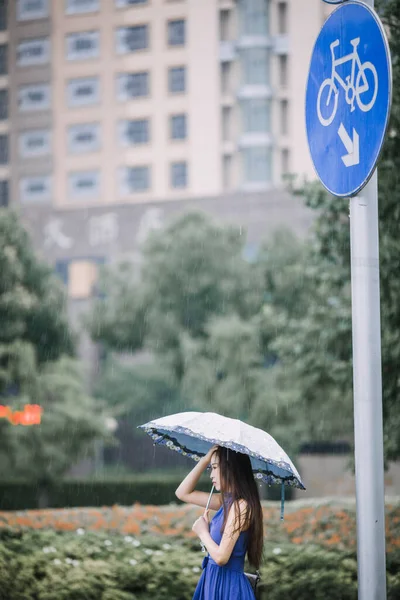 young woman with umbrella on the street