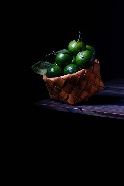 fresh green and black and white fruits on a dark background