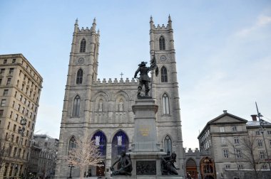 Basilica Notre Dame with statue of Paul de Chomedey de Maisonneuve, founder of Montreal. In Old Town, Montreal, Canada. clipart