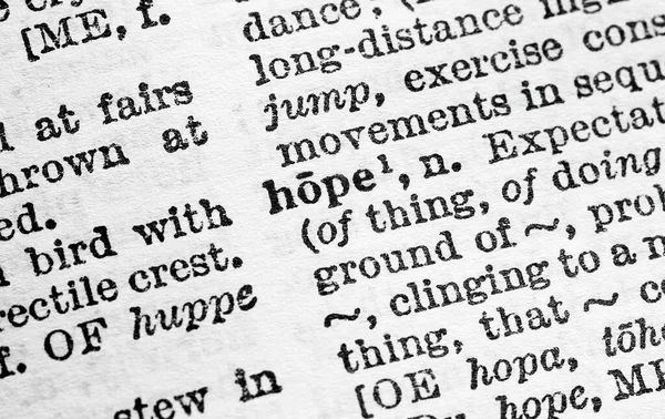 Hope - Closeup macro of English dictionary page with word hope concept