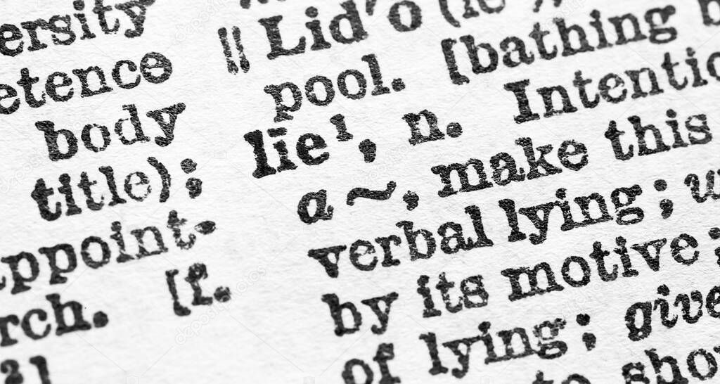 Lie - Closeup macro of English dictionary page with word lie concept
