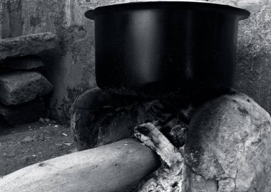 Close up shot of countryside cooking stove or Chula with a black colored circular vessel on it. Black and white-colored shot. Maatir chula or clay stove. clipart