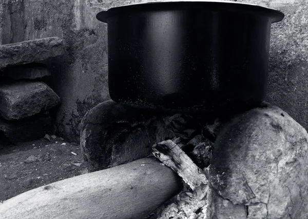 Close up shot of countryside cooking stove or Chula with a black colored circular vessel on it. Black and white-colored shot. Maatir chula or clay stove.