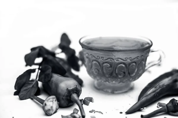 Close up shot of raw cut fresh  chilies. Horizontal shot of Green chili iced tea in a glass cup with some ice cubes in it. Isolated on a white background.