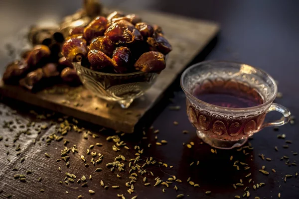 Dates Tea Transparent Glass Cup Some Fennel Seeds Cinnamon Sticks — Stock Photo, Image