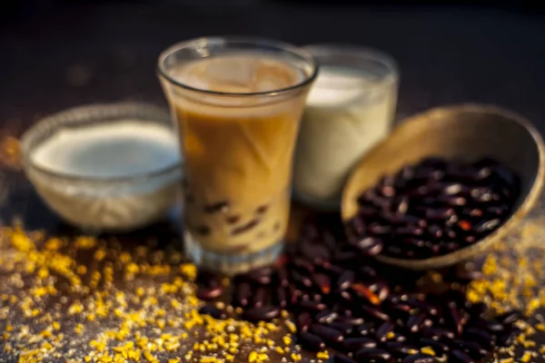 Red bean or kidney bean smoothie in a glass along with some red bean paste, banana, yogurt, milk, and oatmeal. Horizontal shot.