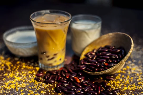 Red bean or kidney bean smoothie in a glass along with some red bean paste, banana, yogurt, milk, and oatmeal. Horizontal shot.